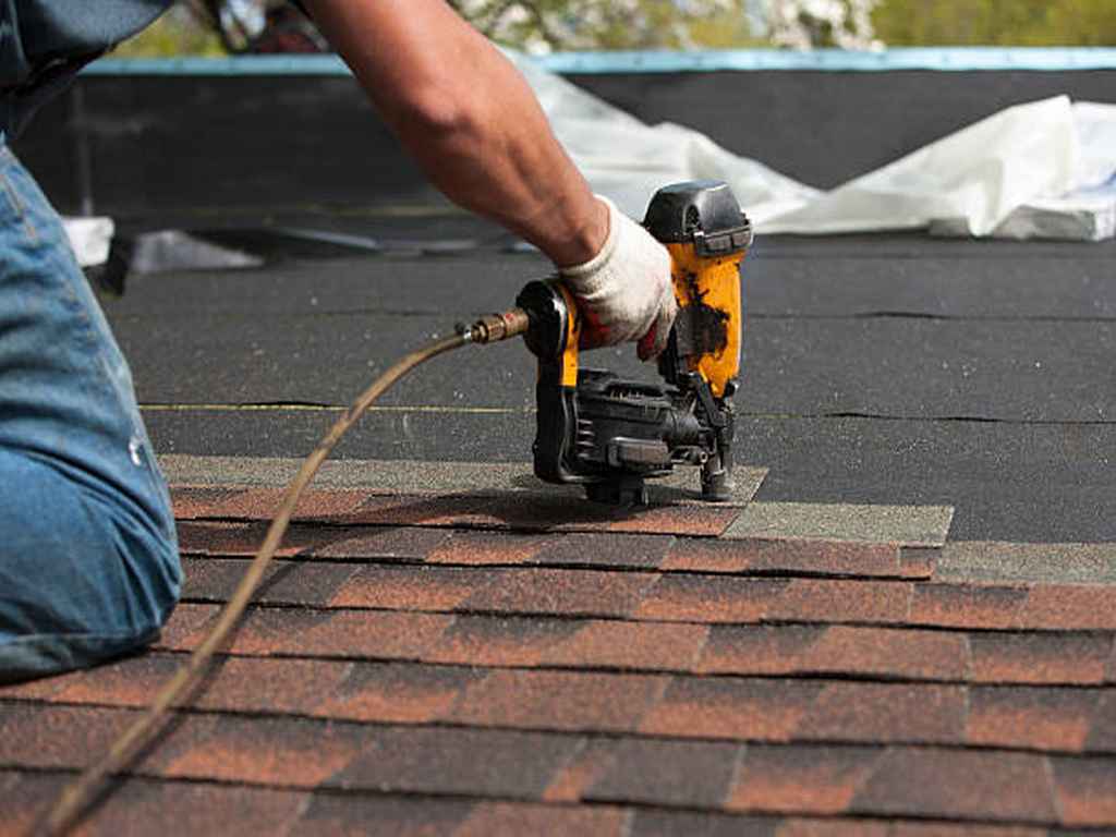roofing contractor in Plano installing asphalt shingles